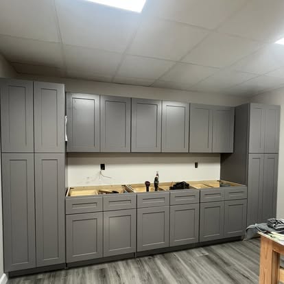 Basement cabinetry wall with storage and work surface