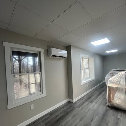 Finished basement room with windows and flooring