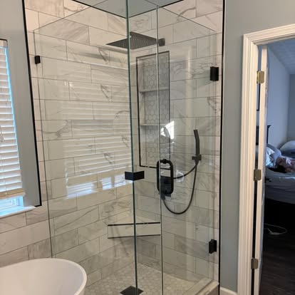 Corner glass shower with marble look tile
