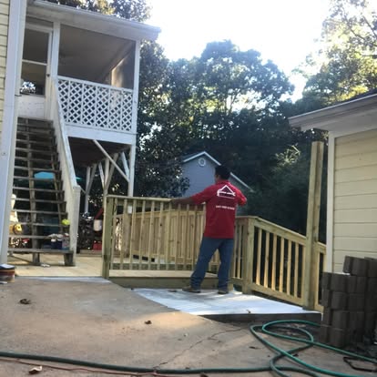 Worker installing deck railing and ramp