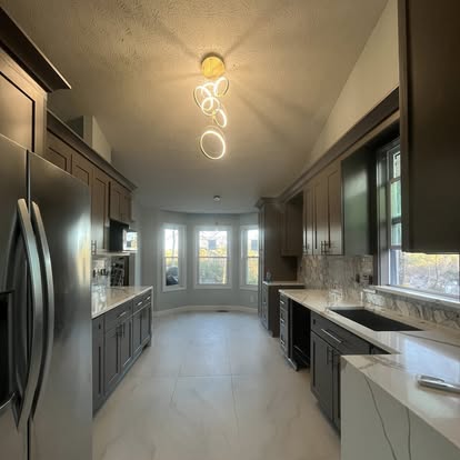 Long galley kitchen remodel with dark cabinets and bright tile floor
