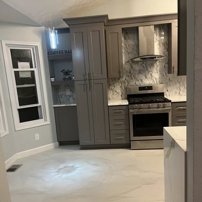 Kitchen with dark cabinetry and coffee bar detail