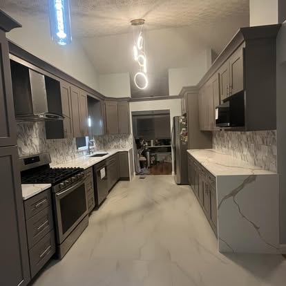 Wide kitchen remodel with range and tall cabinetry