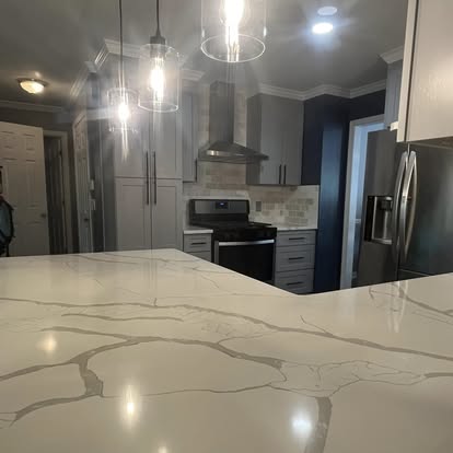 Close-up of quartz countertop and pendant lights in kitchen